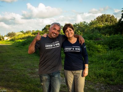 Cesar Milan posing with a team member